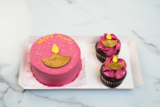 Pink Diwali Diya Bento Cake Hamper with golden diya decoration and two cupcakes by Dreamy Delights by Sidra in Dubai