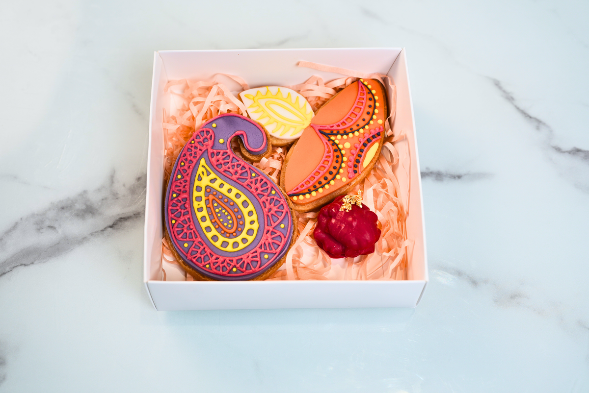 Diwali mini cookie gift box with two decorated festive cookies and a chocolate-dipped peanut butter walnut by Dreamy Delights by Sidra in Dubai