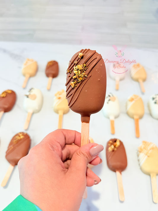 Chocolate drizzle cakesicle with crunchy toppings