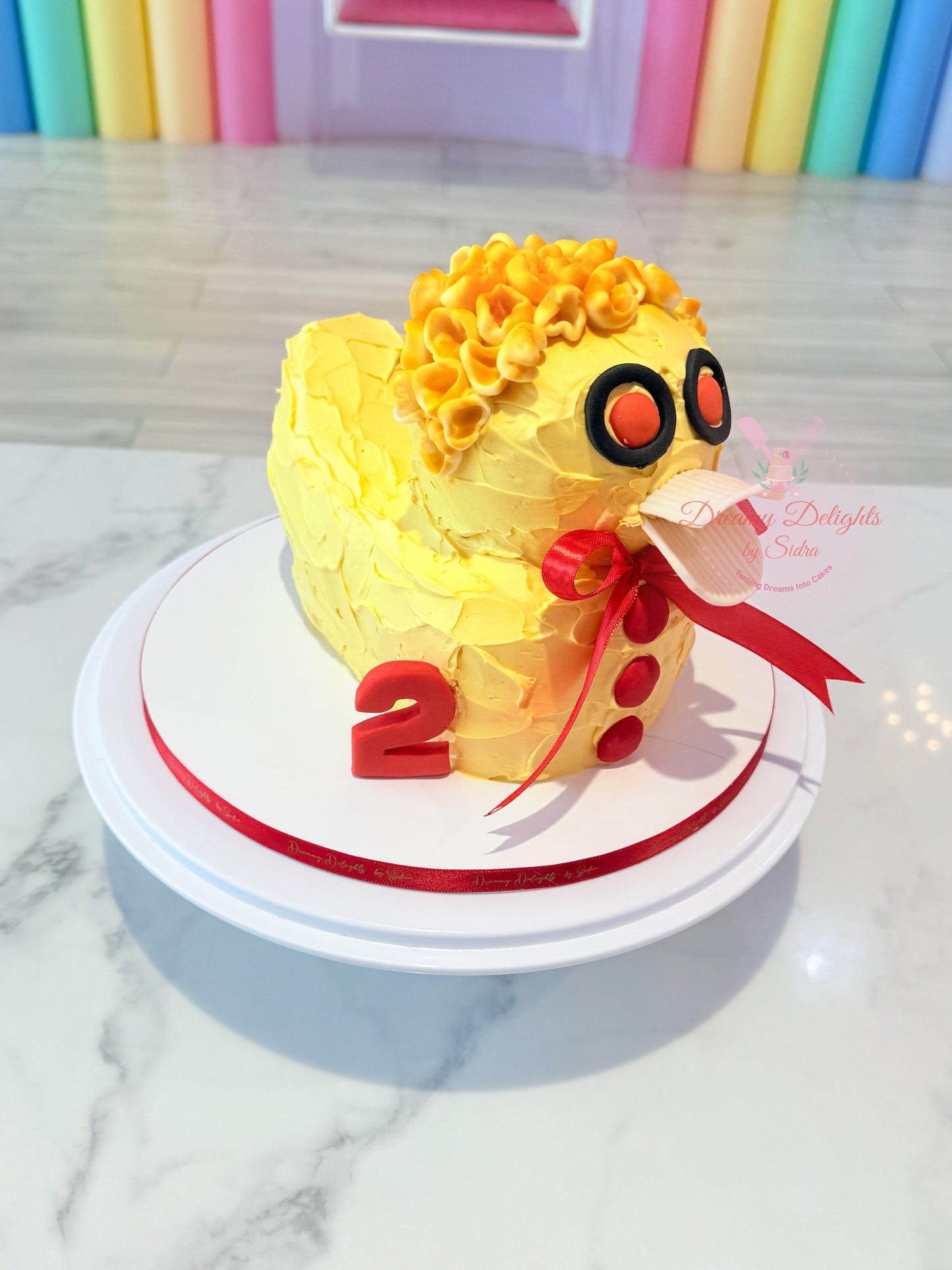Duck birthday cake for kids and boys with yellow theme and custom age topper in Dubai