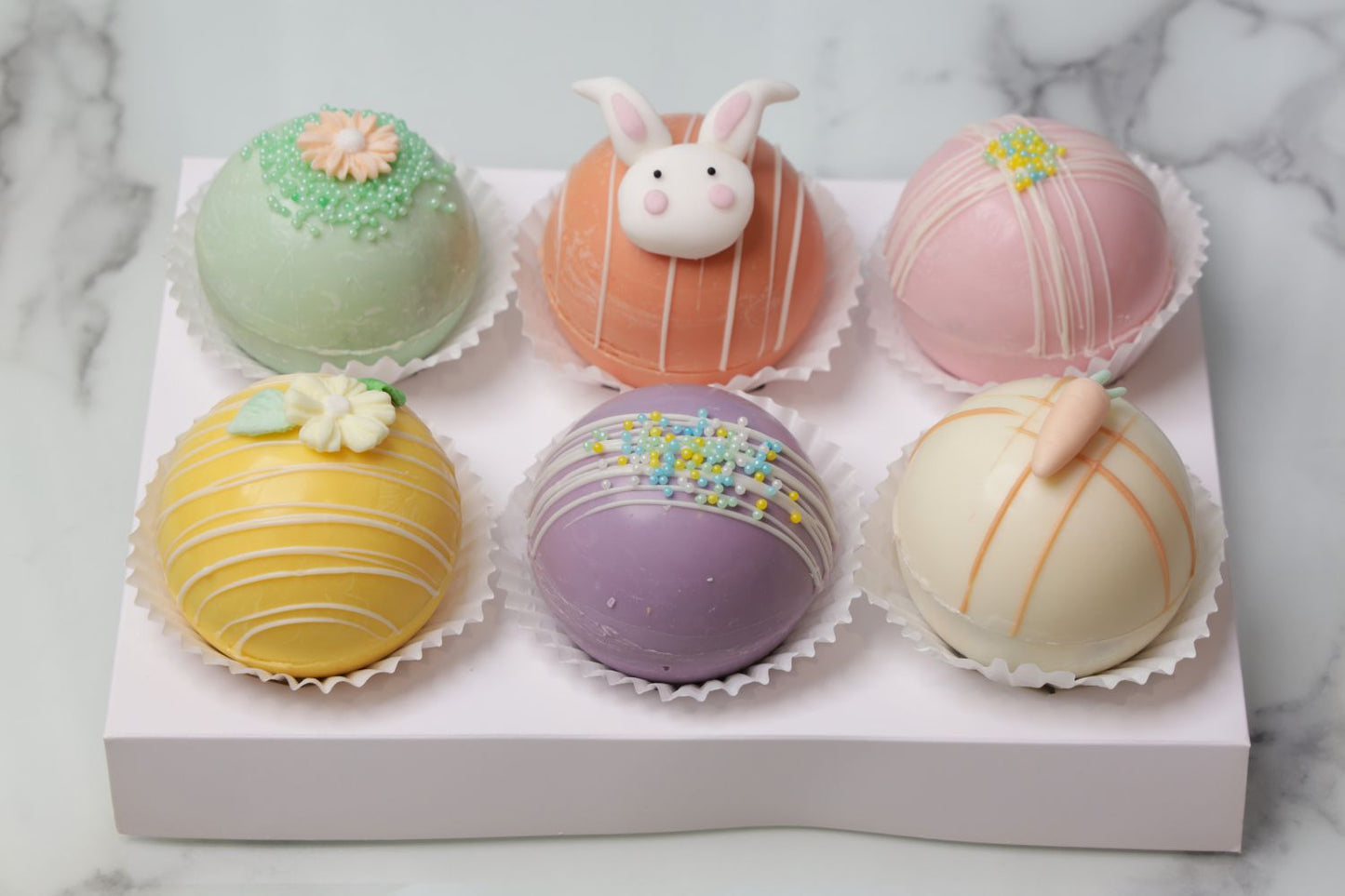 Easter hot cocoa bombs Dubai with pastel chocolate shells and decorations