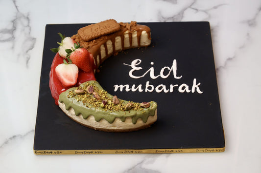 Eid Mubarak moon shaped cheesecake with lotus strawberry and pistachio flavors Dubai