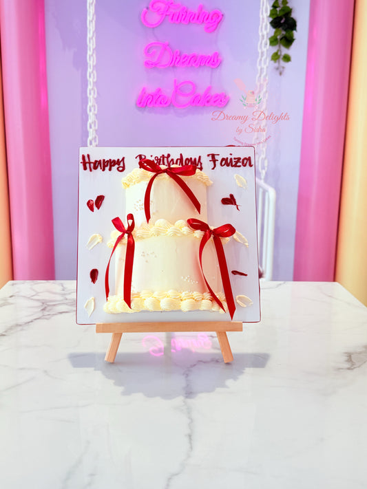 Card with a birthday cake design and red ribbons on a marble surface with a colorful background.
