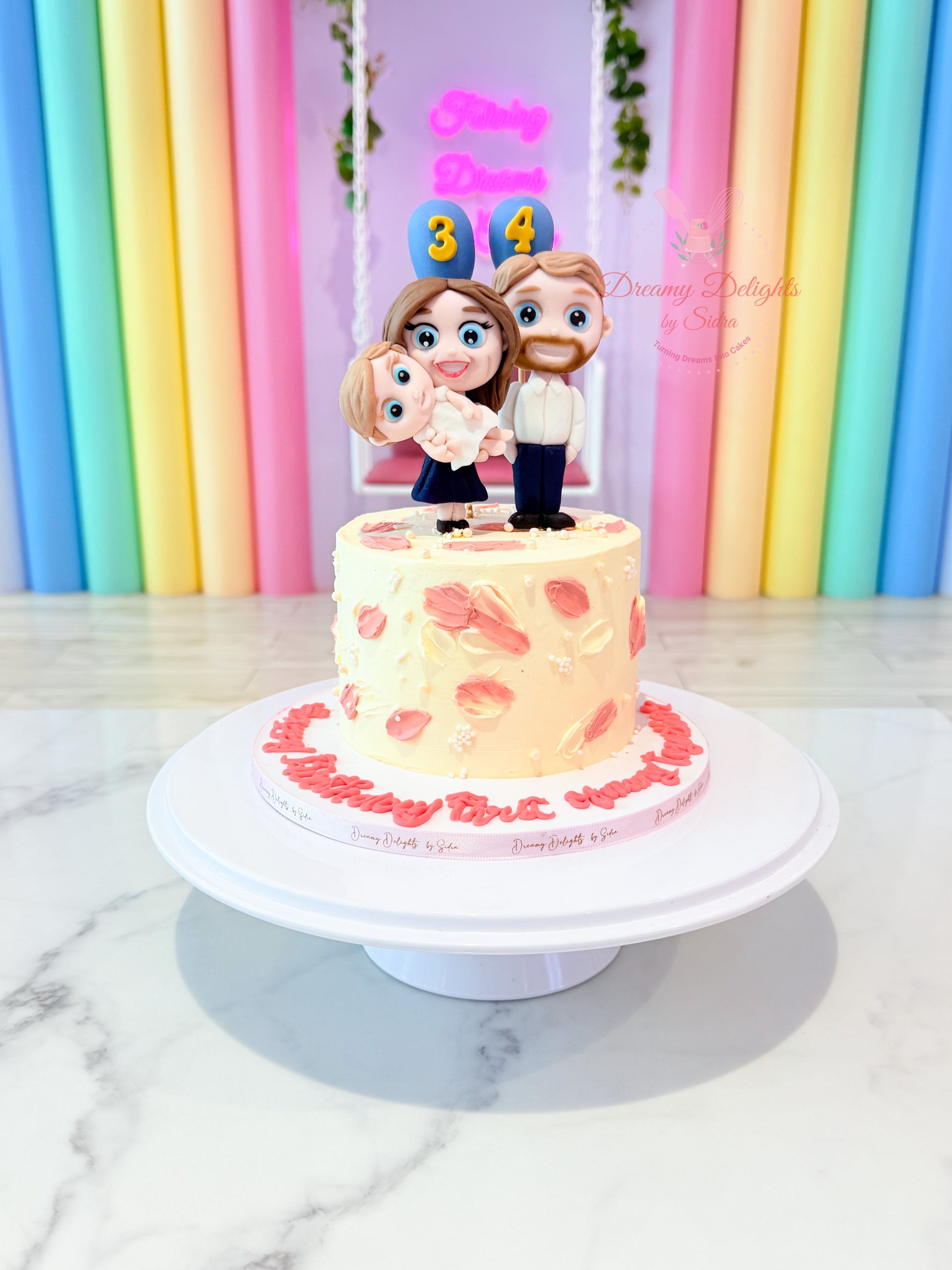 Family cake with custom fondant figurines and buttercream finish