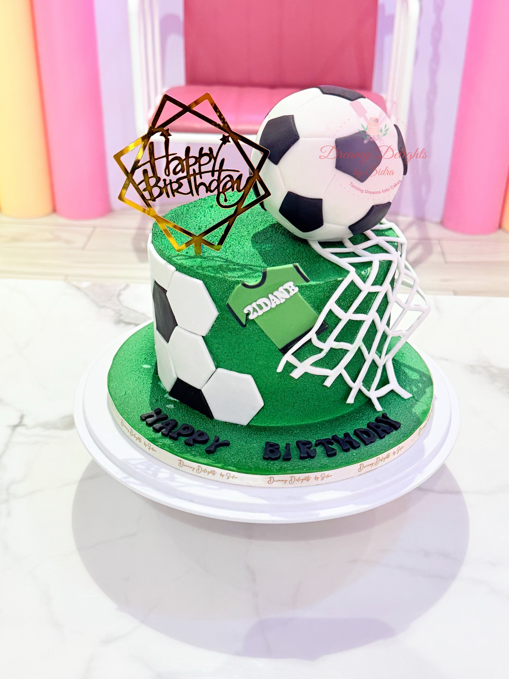 Football cake for boys with soccer theme, green grass finish, fondant football details, goal net design, and kids birthday celebration setup