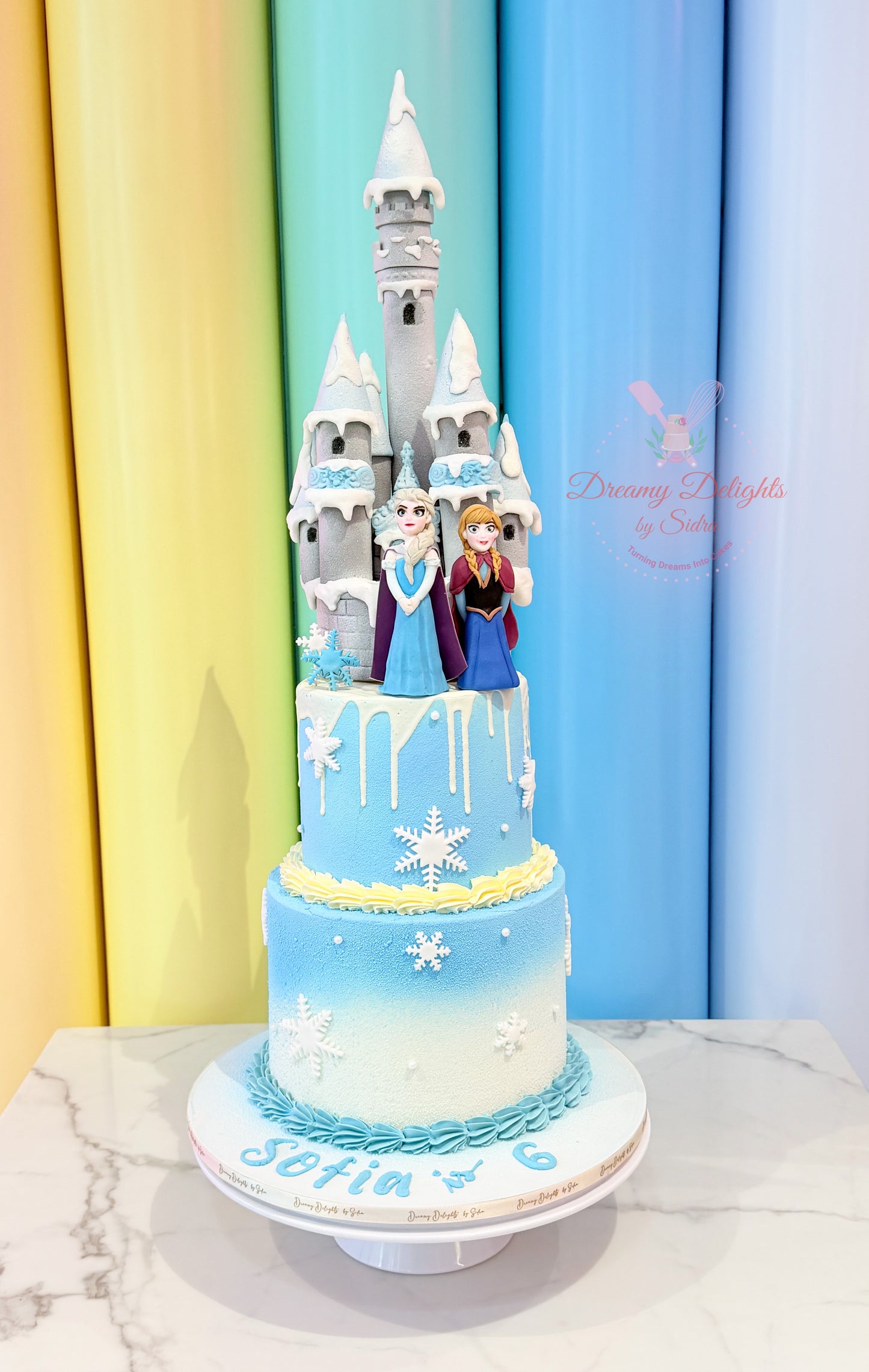 Frozen Princess Castle Cake with snowflake decorations and magical castle design for girls in Dubai