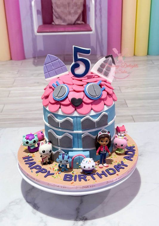 Gabby's Dollhouse cake Dubai with pink frosting, colourful jewels, heart decorations and cute bunny topper by Dreamy Delights by Sidra.