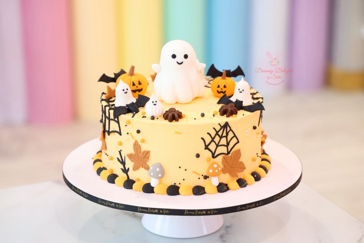 Ghost Web Halloween cake Dubai with cute ghosts, pumpkins, bats and spiderweb decorations by Dreamy Delights by Sidra


