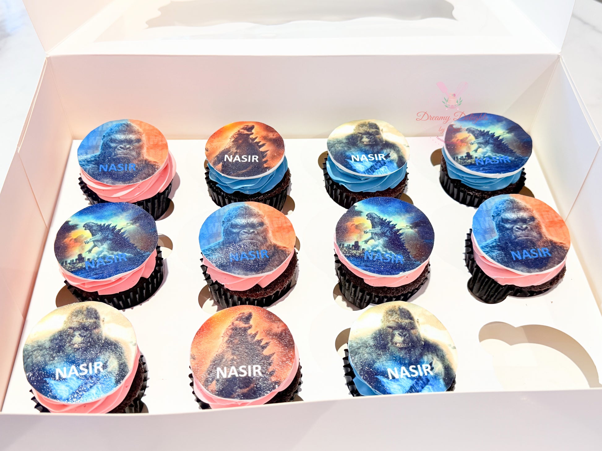 Godzilla themed cupcakes with edible printed toppers and custom name design for kids birthday in Dubai