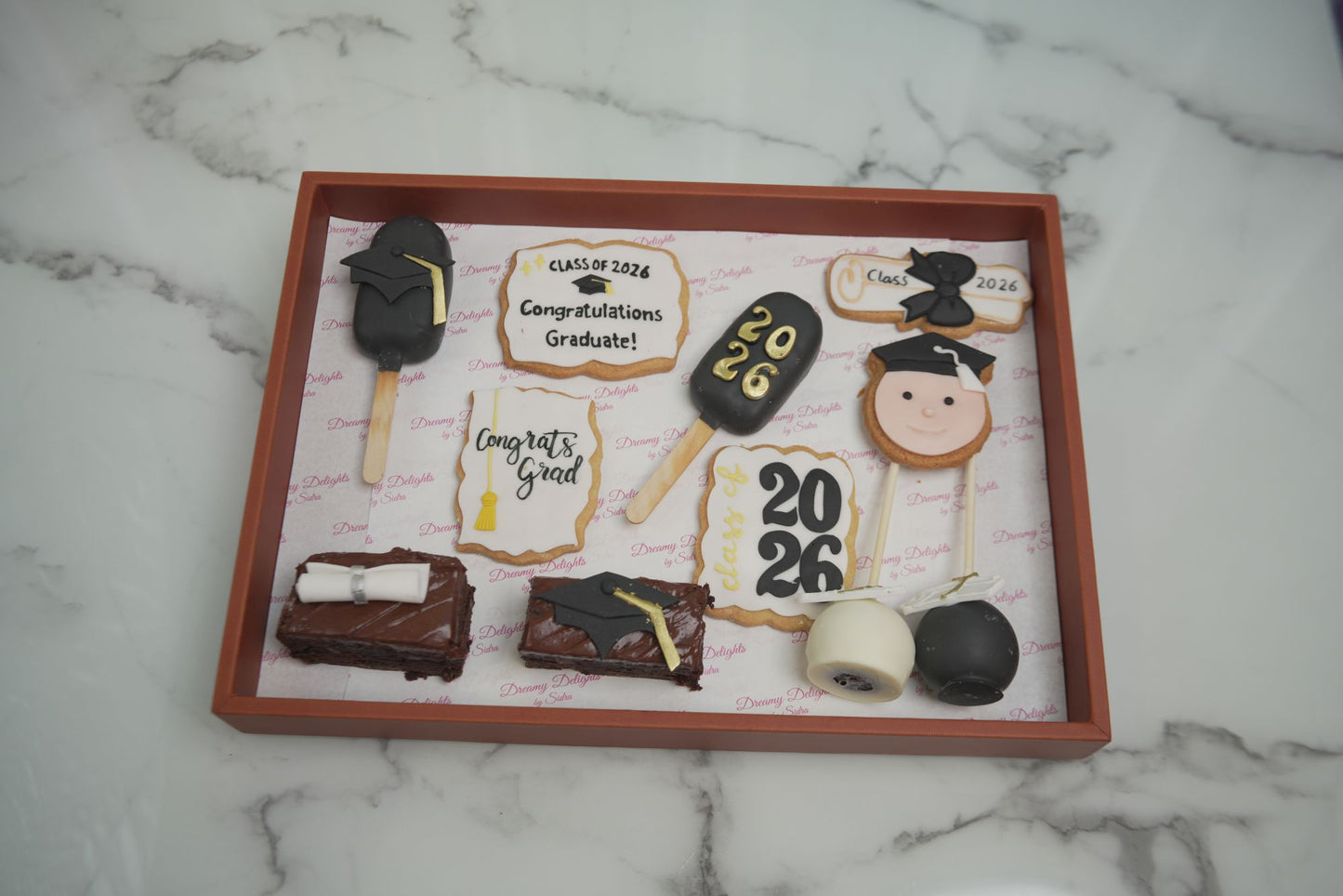 Graduation celebration dessert tray bundle with cakesicles, brownies, cookies and cake pops for school graduation, Class of 2026 parties and graduation celebrations in Dubai Hills