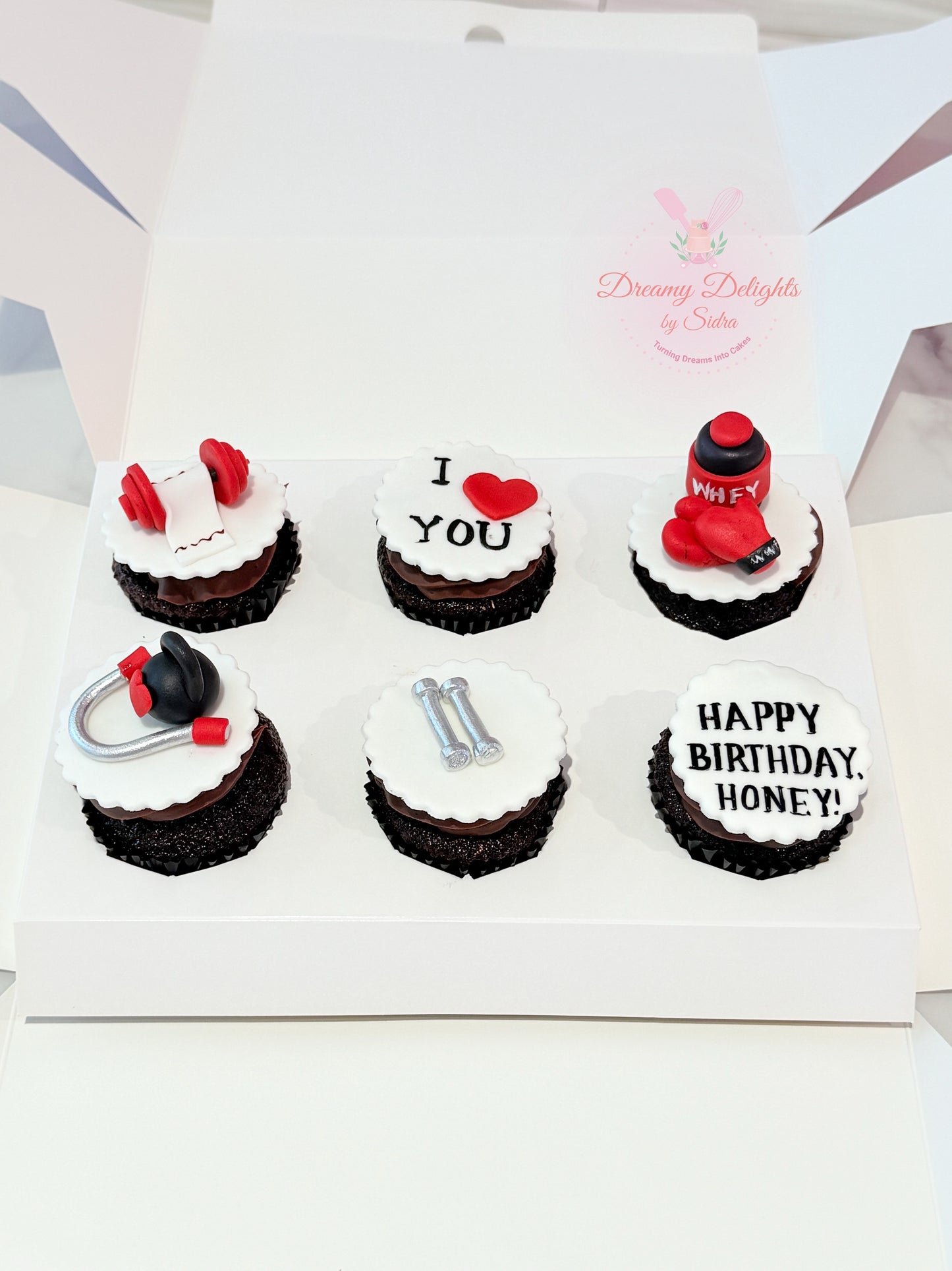 Gym birthday cupcakes with fitness theme toppers for husband celebration in Dubai