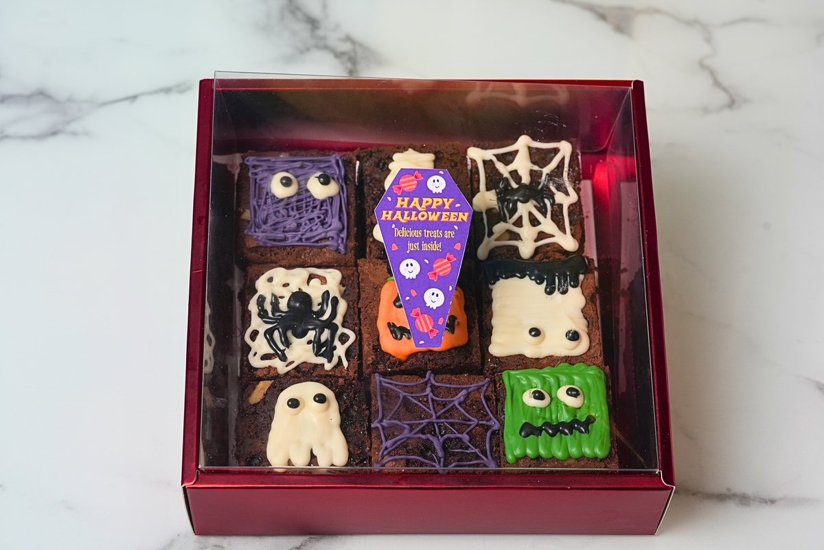 Halloween spooky brownies decorated with ghosts, spiders, mummies, and monsters in a gift box by Dreamy Delights by Sidra in Dubai.