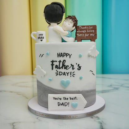 Father's Day cake with figurines and text on a marble surface