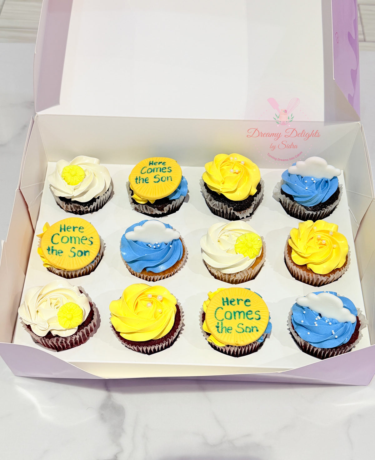 Here Comes the Son cupcakes Dubai with yellow, blue and white floral frosting by Dreamy Delights by Sidra