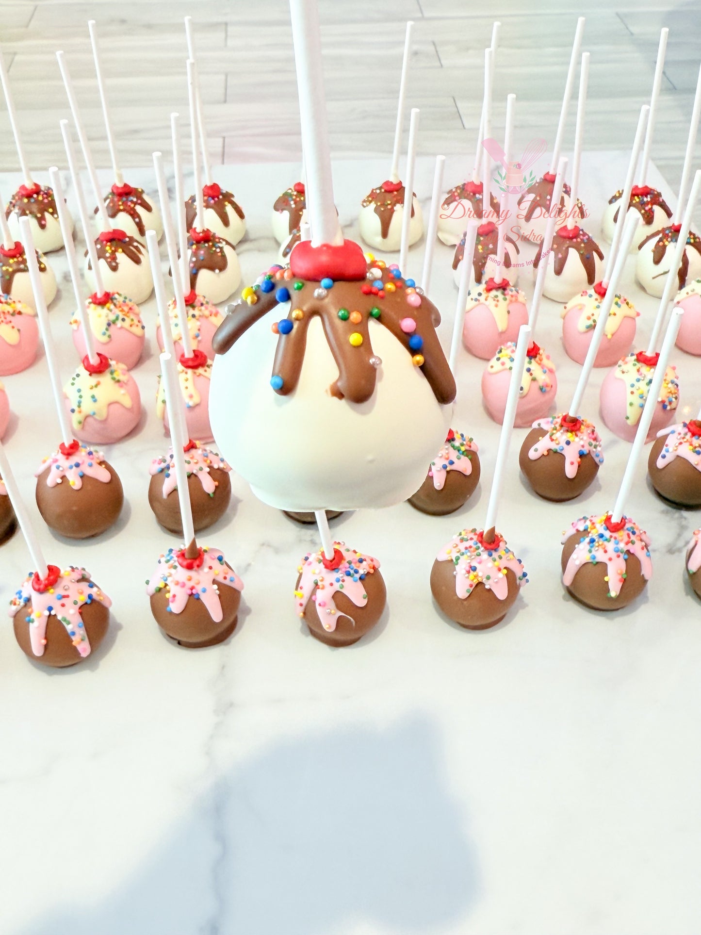 Ice cream themed cake pops with sprinkles for kids birthday party dessert table Dubai