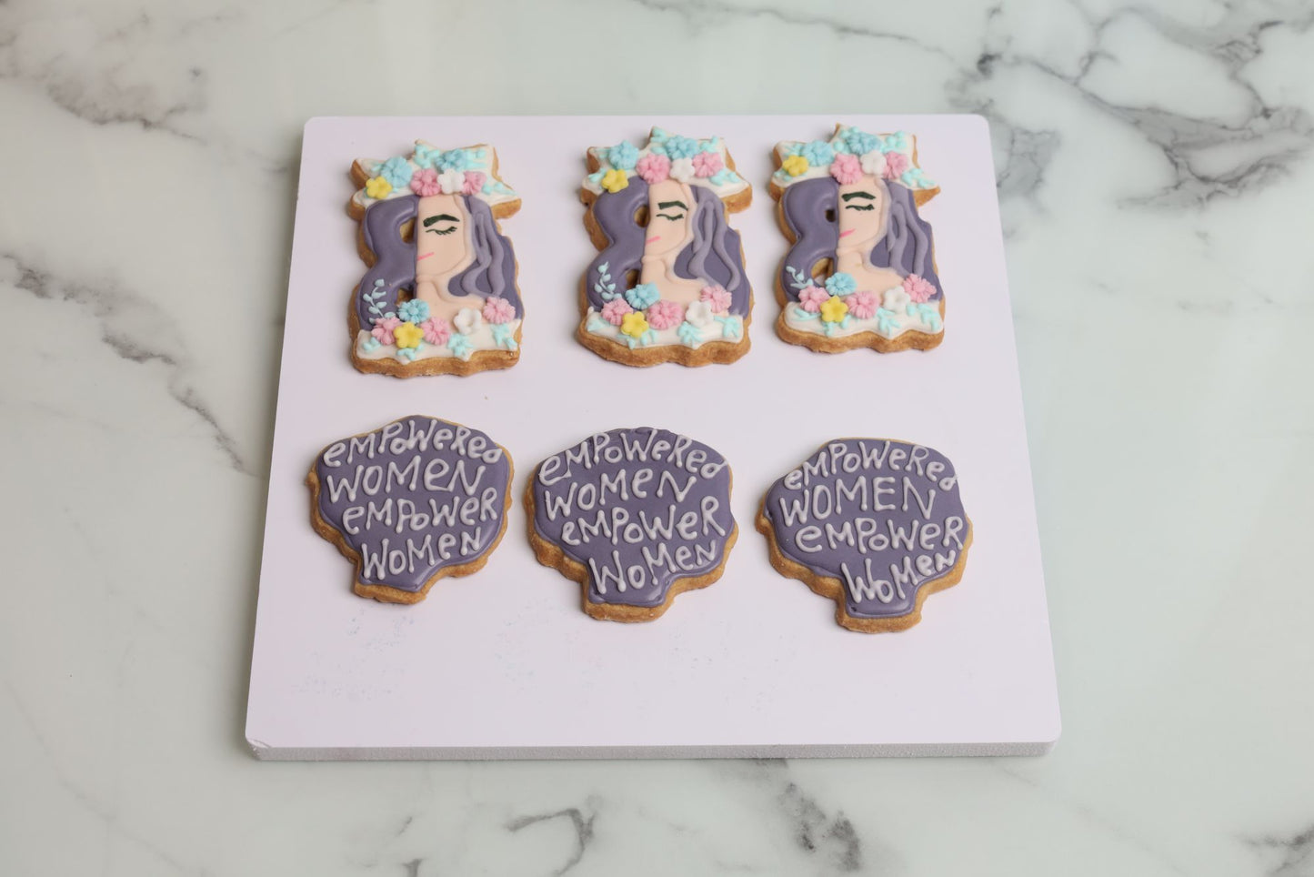 International Women's Day empowered woman decorated sugar cookie with floral crown and pastel flower design