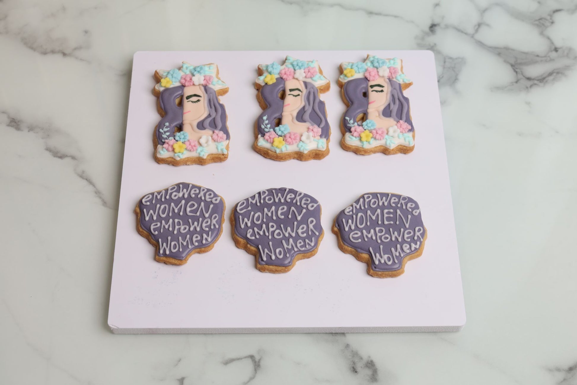 International Women's Day empowered woman decorated sugar cookie with floral crown and pastel flower design