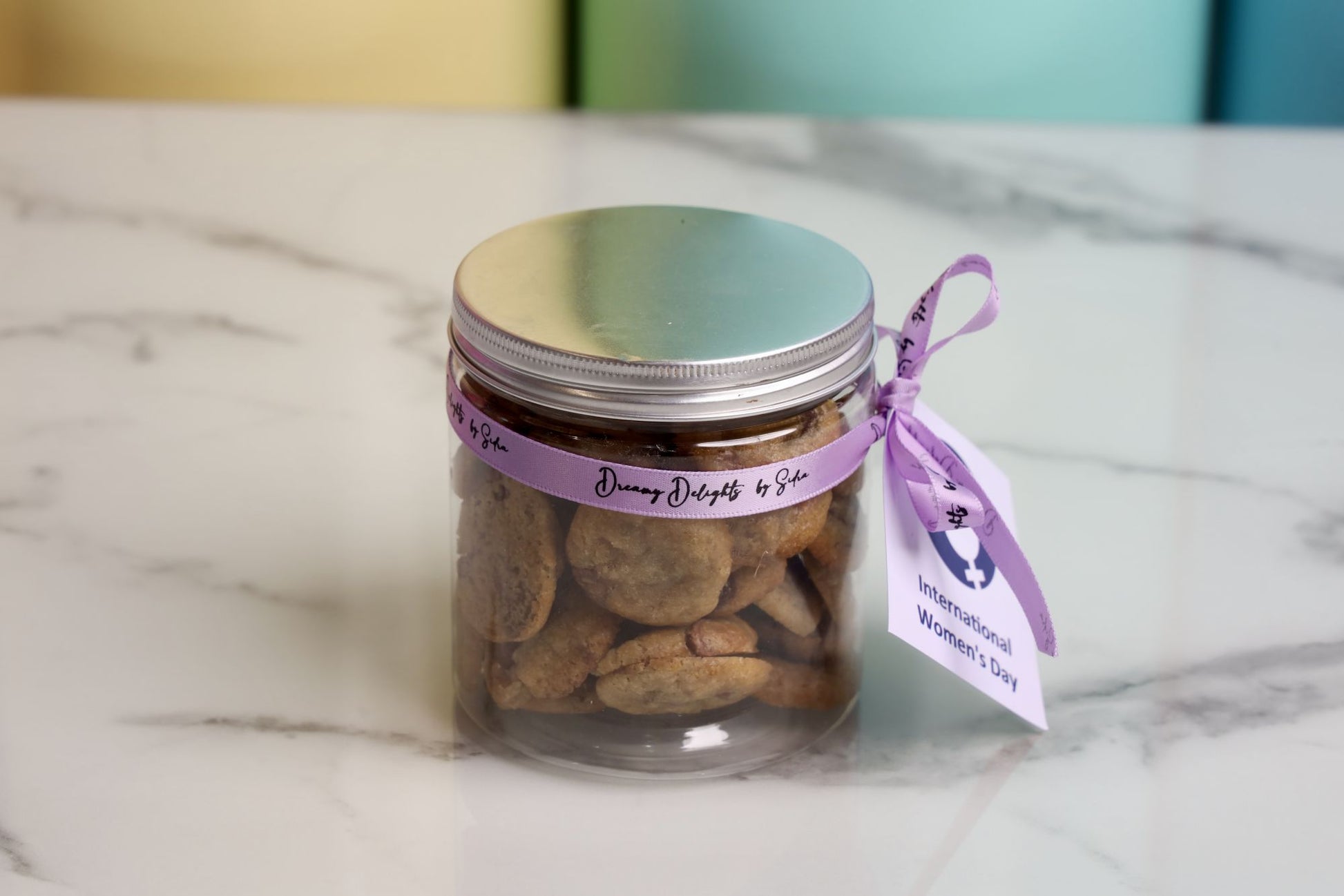 International Women's Day mini chocolate chip cookies jar with purple ribbon and Women's Day message tag