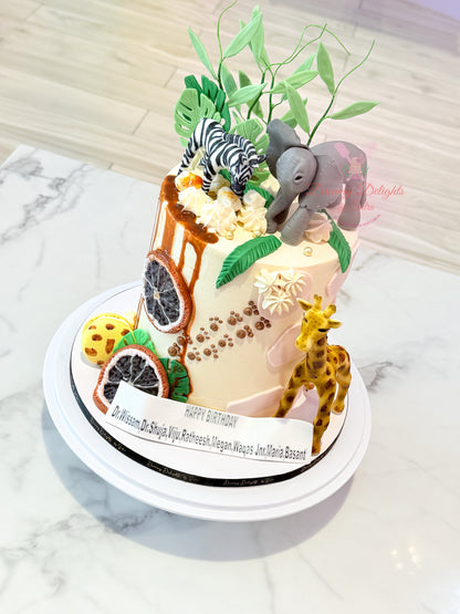 Decorative cake with animal figurines on a marble surface