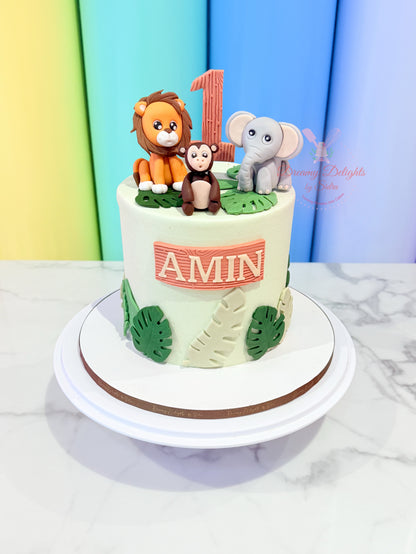 Children's birthday cake with animal figurines and 'Amin' on a colorful background