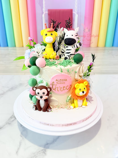 Jungle cake for girls with fondant animal figures and greenery design