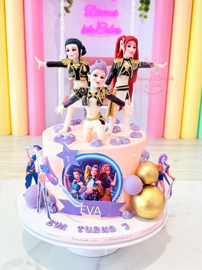 K-pop cake Dubai with cute character toppers, pastel frosting and golden decorations by Dreamy Delights by Sidra