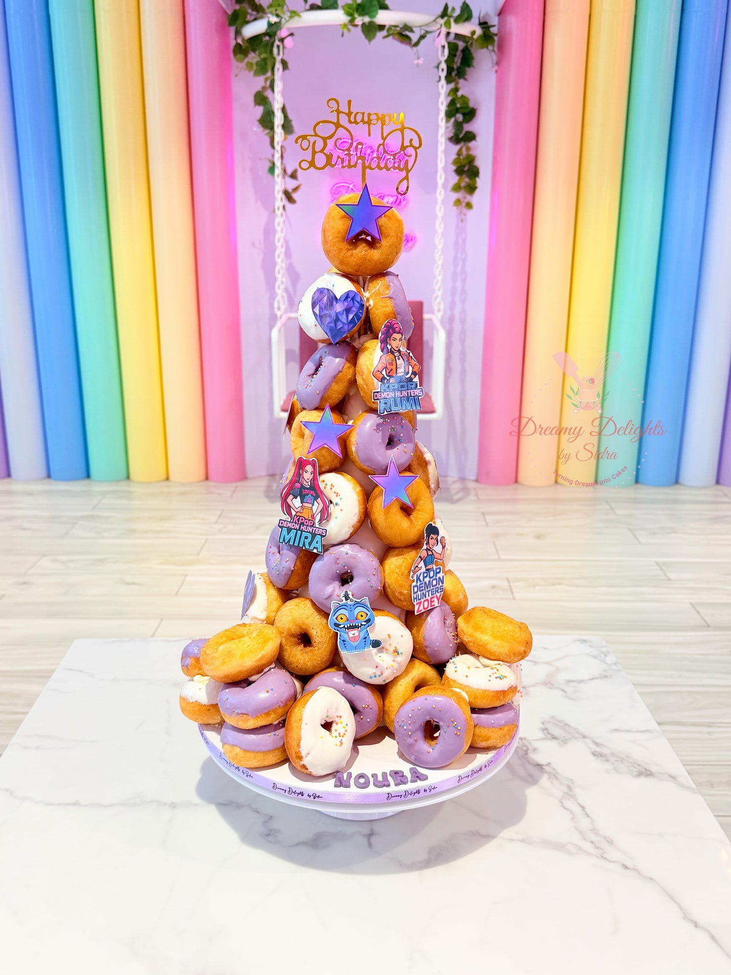 KPop themed donut tower with pastel glazed donuts for kids birthday party