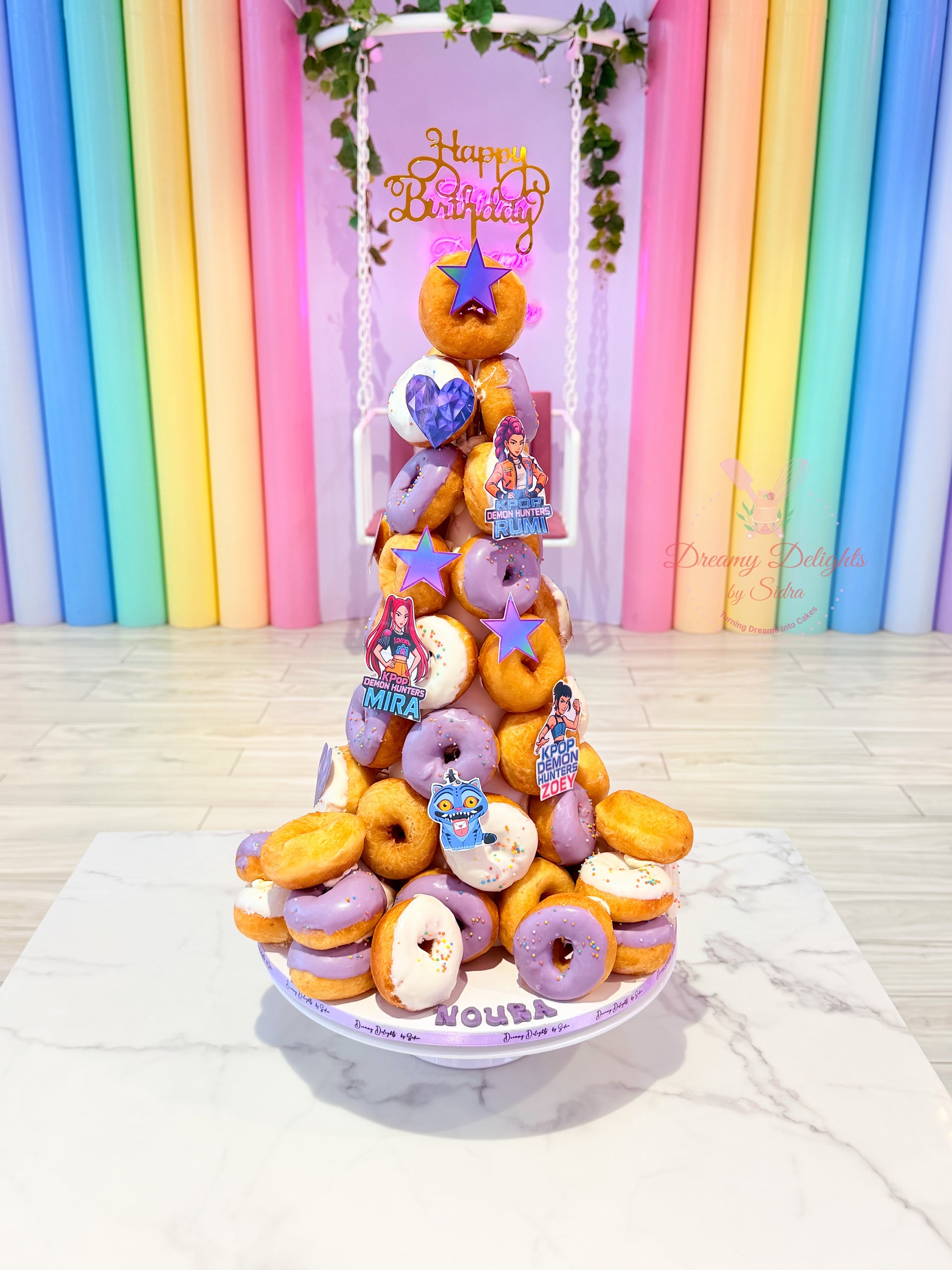 KPop themed donut tower with pastel glazed donuts for kids birthday party