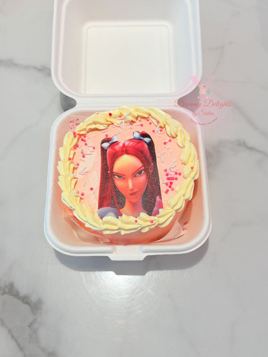 KPop Mira Bento Cake with pink frosting, character image, yellow piped border and colourful sprinkles in Dubai