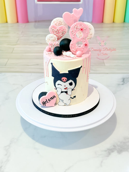 Small birthday cake with cartoon character and balloons on a white surface