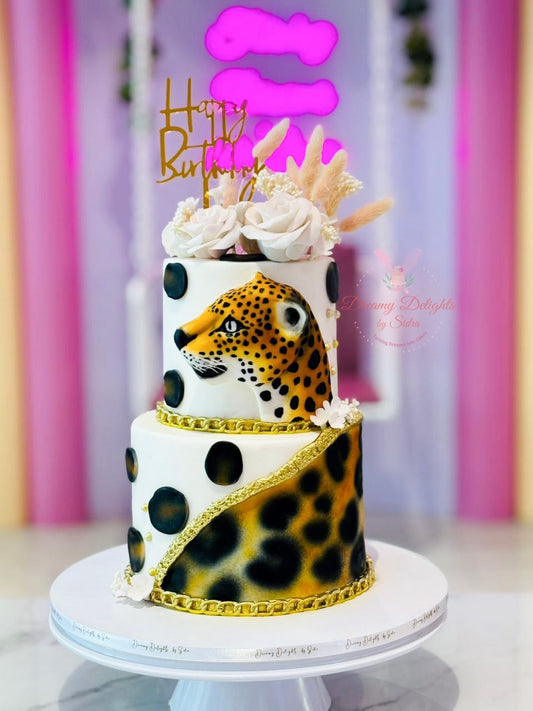 Two tier Leopard themed custom birthday cake with hand painted design and gold accents in Dubai