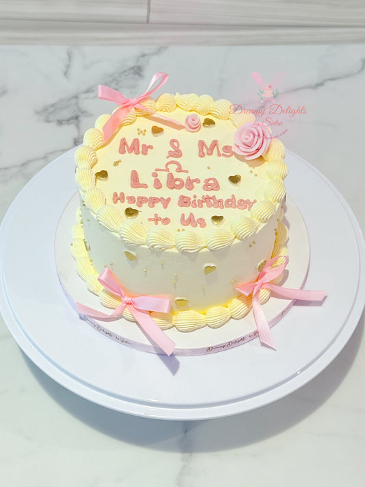 Libra vintage buttercream ribbon bow birthday cake with retro piping and gold heart decoration custom cake Dubai
