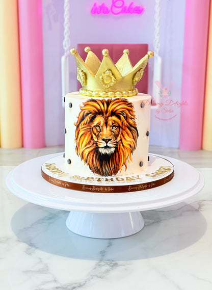 Cake with lion design and crown on a white stand against a colorful background