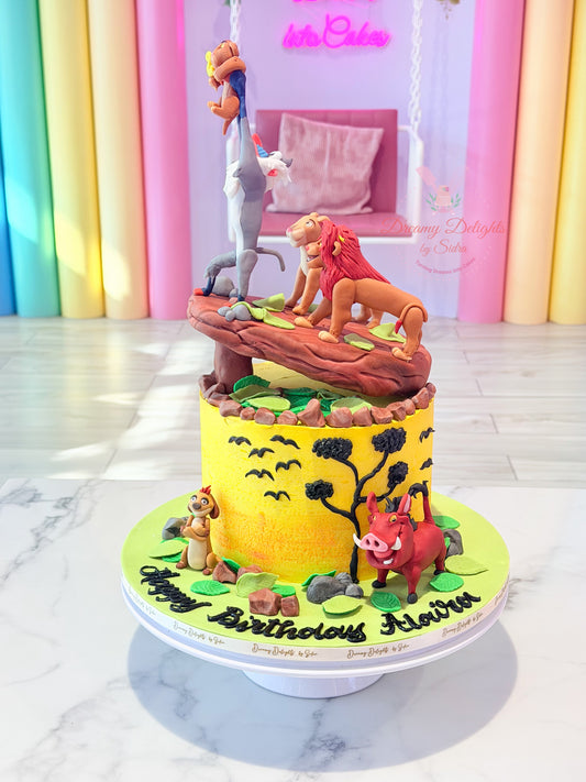 Lion King birthday cake Dubai with yellow frosting, savannah scenery, jungle leaves and Lion King character figurines by Dreamy Delights by Sidra.