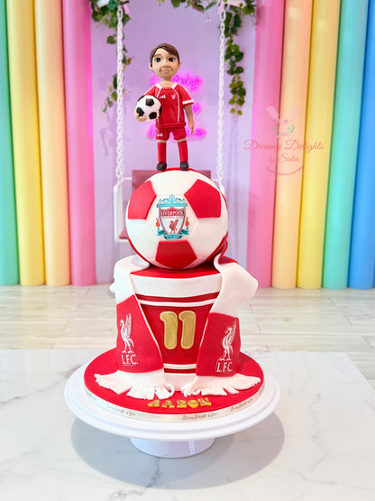 Liverpool Football Club Cake with red and white football topper, footballer figurine and scarf decorations in Dubai