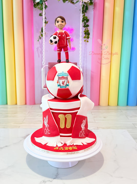 Liverpool Football Club Cake with red and white football topper, footballer figurine and scarf decorations in Dubai