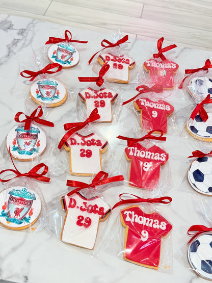 Liverpool football cookies featuring club crest and personalised football jersey designs, individually wrapped with red ribbon bows by Dreamy Delights by Sidra in Dubai.