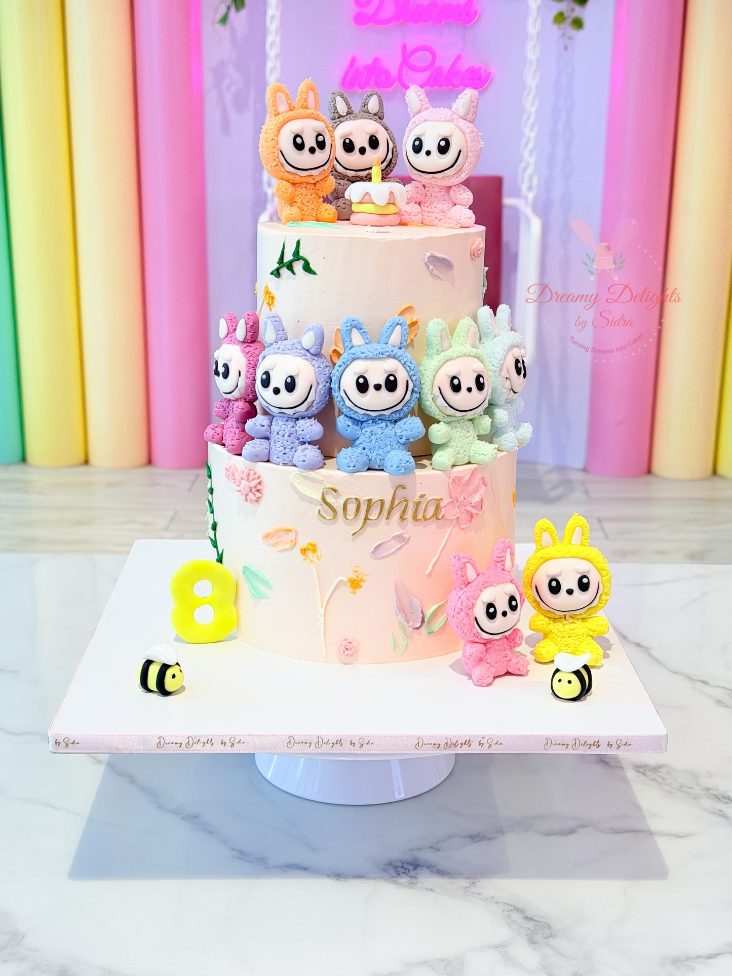 Lots of Labubu Cake with colorful character toppers, customized kids birthday cake for girls in Dubai