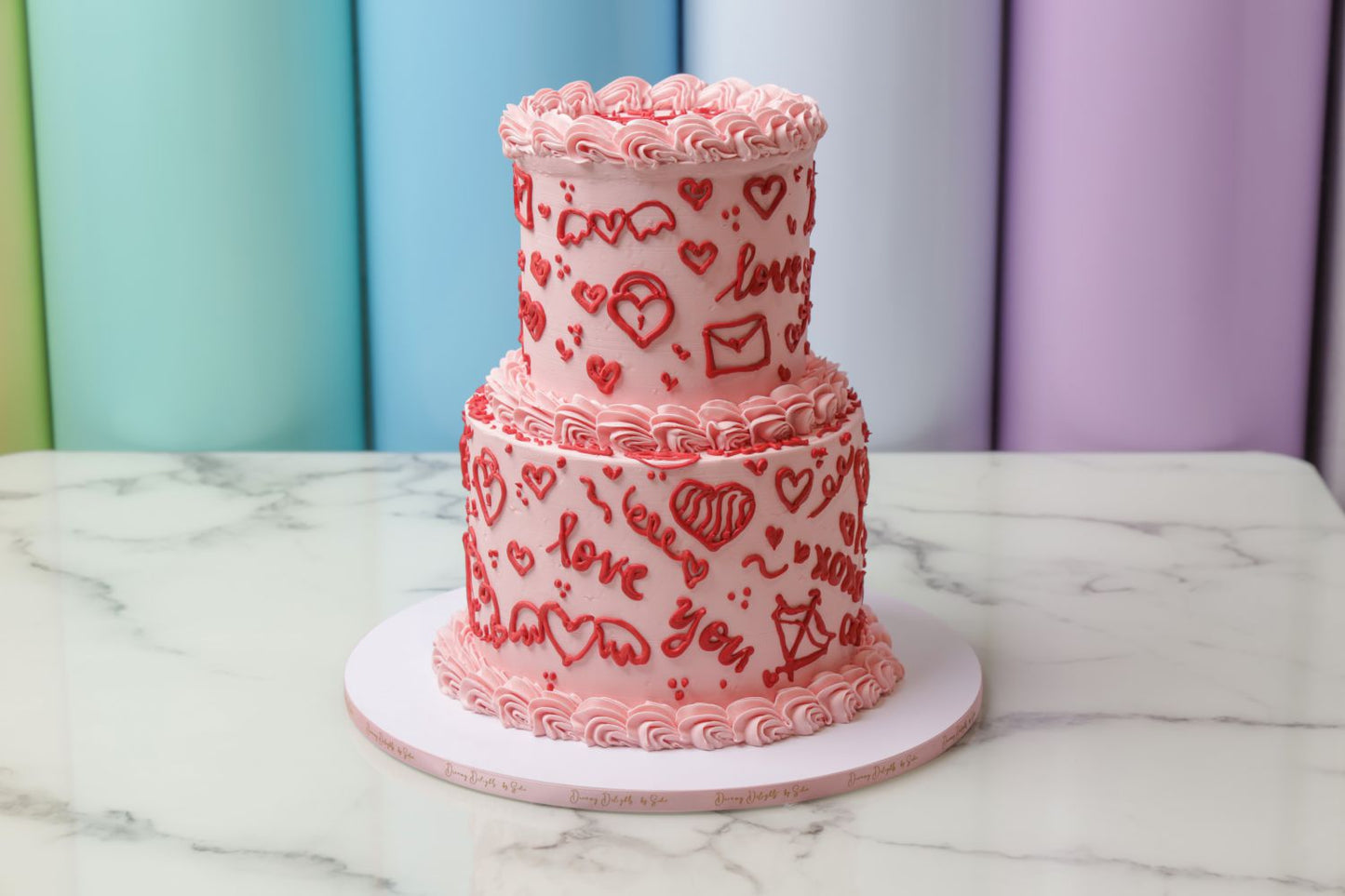 Valentine’s Day Love Sign Language cake with pink frosting and heart details by Dreamy Delight by Sidra