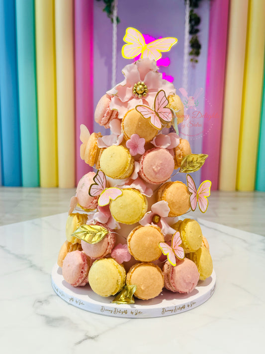 Colorful macaron tower with butterflies against a multicolored background