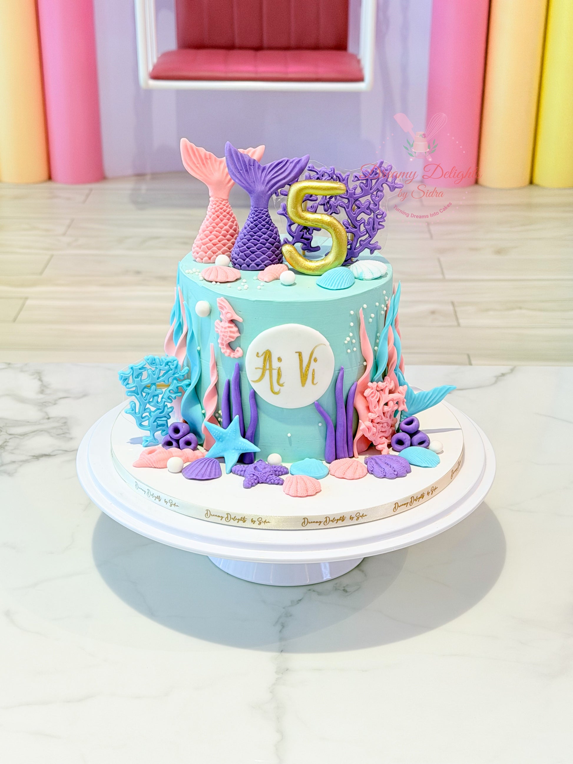 mermaid birthday cake Dubai with ocean theme decorations and shells