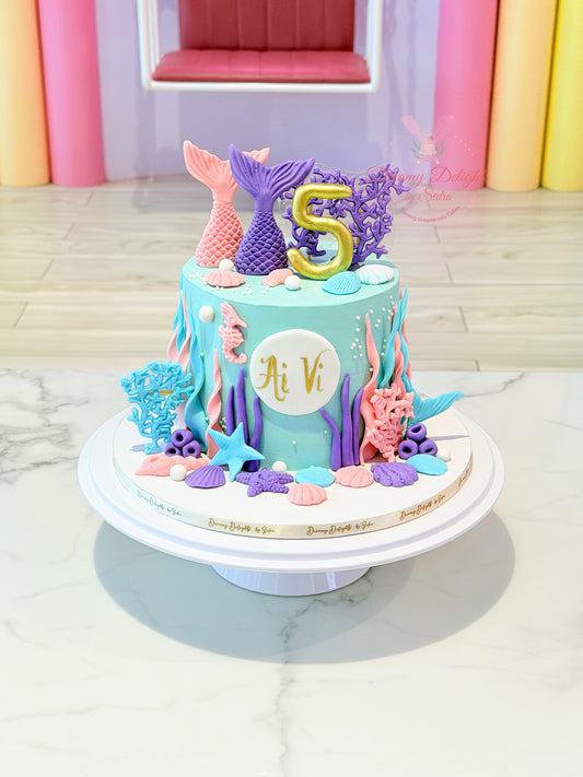 mermaid birthday cake Dubai with ocean theme decorations and shells