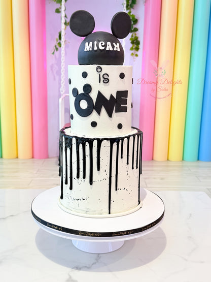 Mickey Mouse Cake with black mouse ears, white frosting, polka dots and black drip icing in Dubai