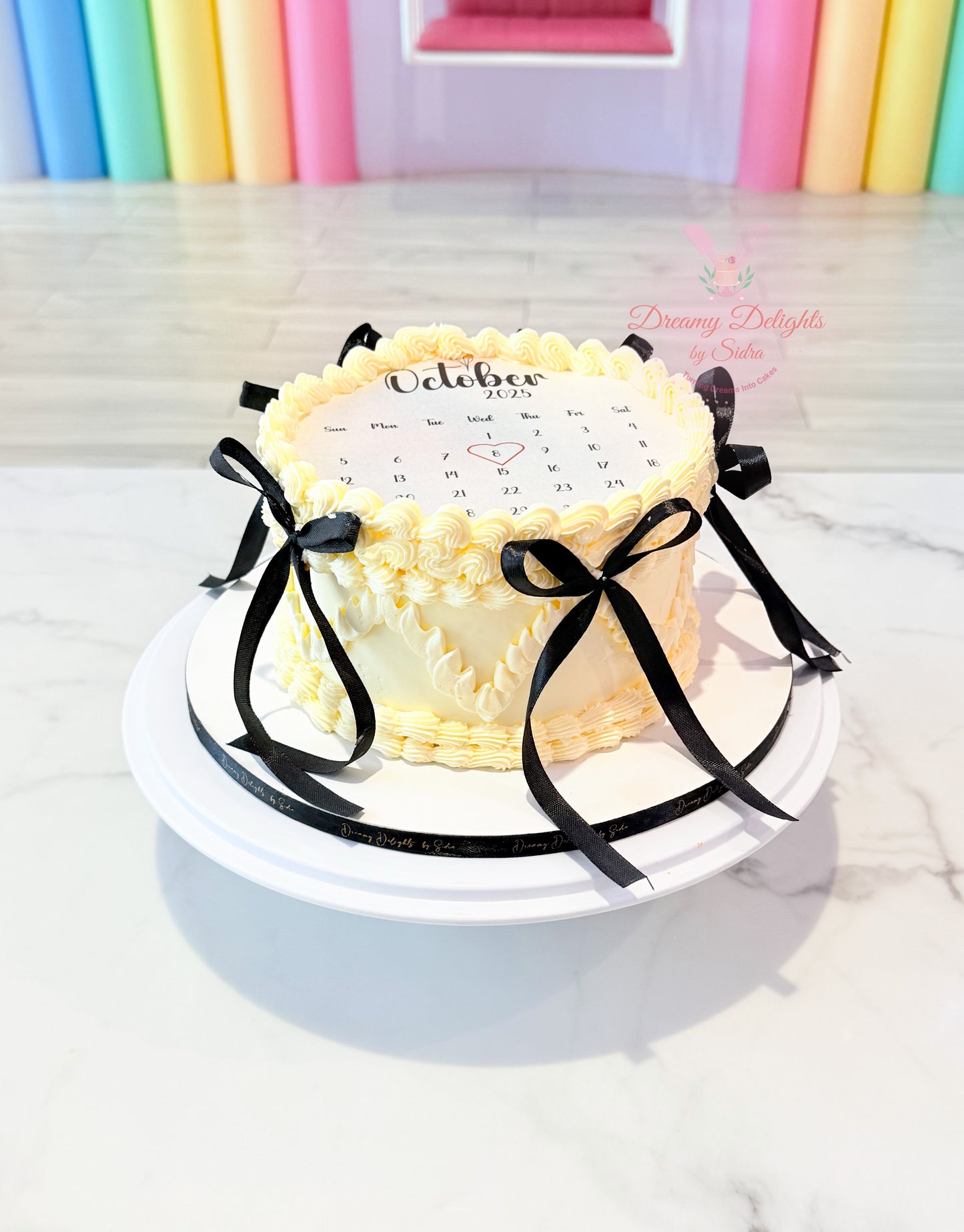 Minimal calendar burnaway cake with black ribbon accents and highlighted date for men birthday in Dubai