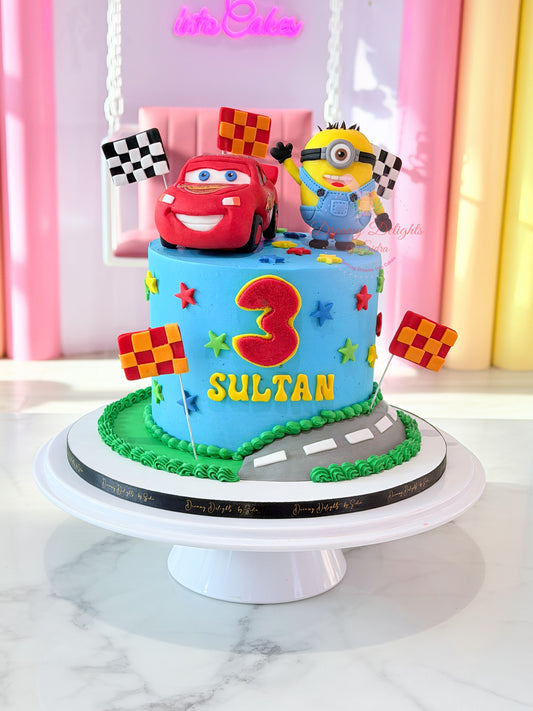 Personalized Minions and Lightning McQueen birthday cake with racing flags, colorful stars, road design, and custom name topper for boys in Dubai.
