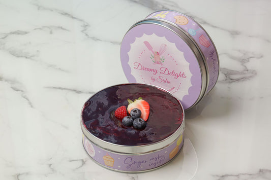 Mix berries tiramisu cake with fresh strawberries and blueberries layered mascarpone dessert in decorative tin Dubai