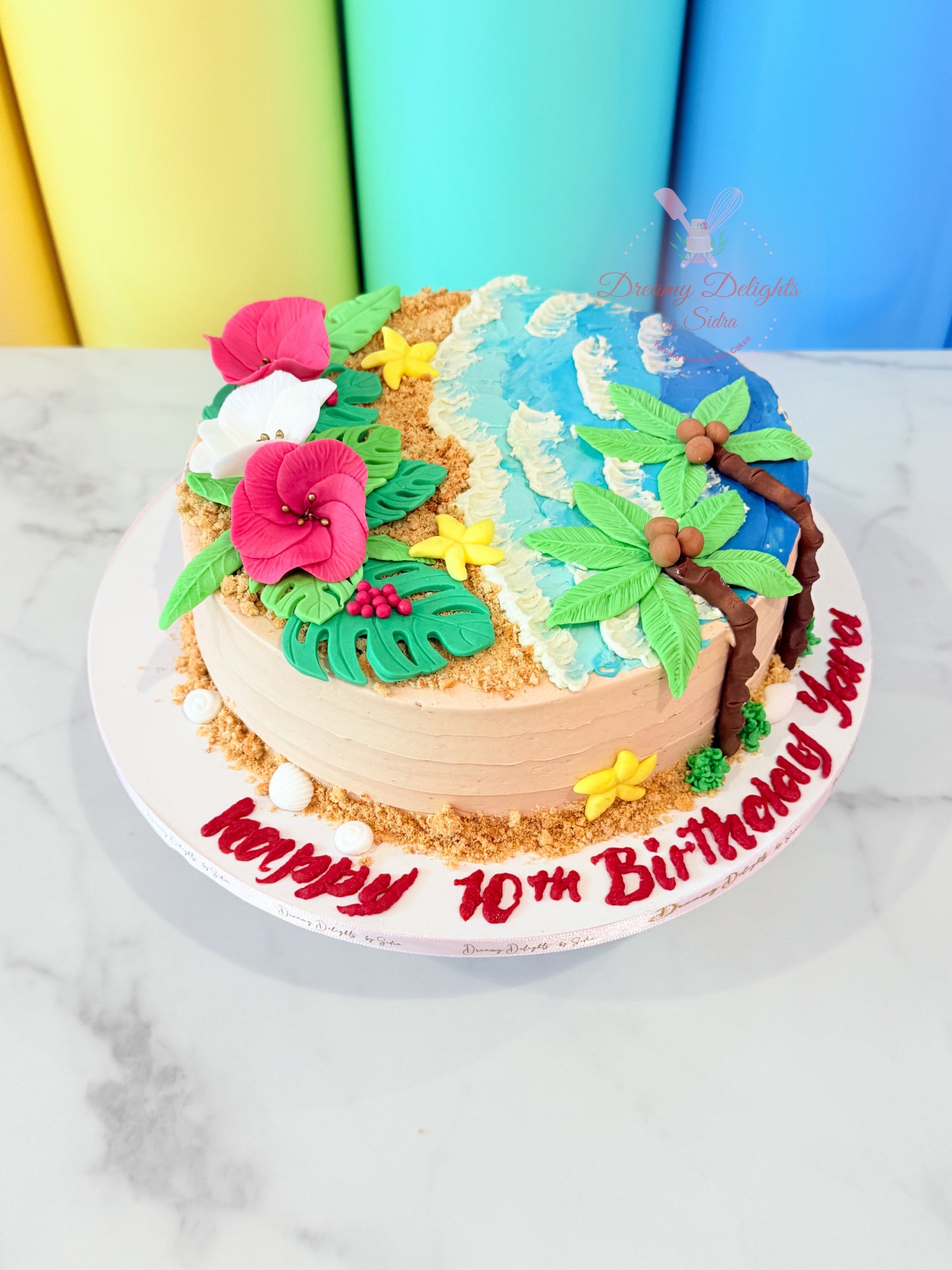 Moana tropical beach theme birthday cake with ocean waves palm trees and flowers for girls birthday party in Dubai