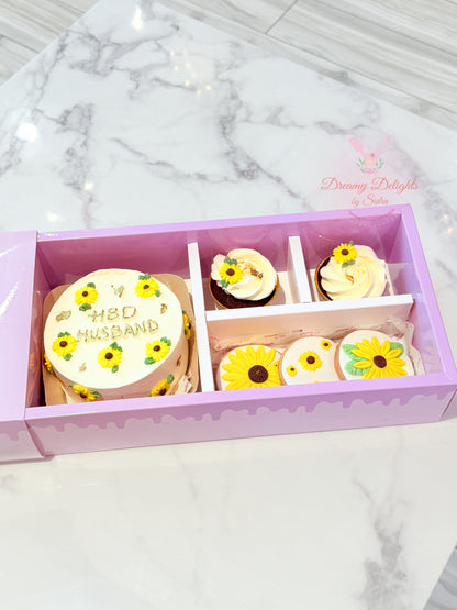 Decorative cookies with sunflower designs in a box on a marble surface