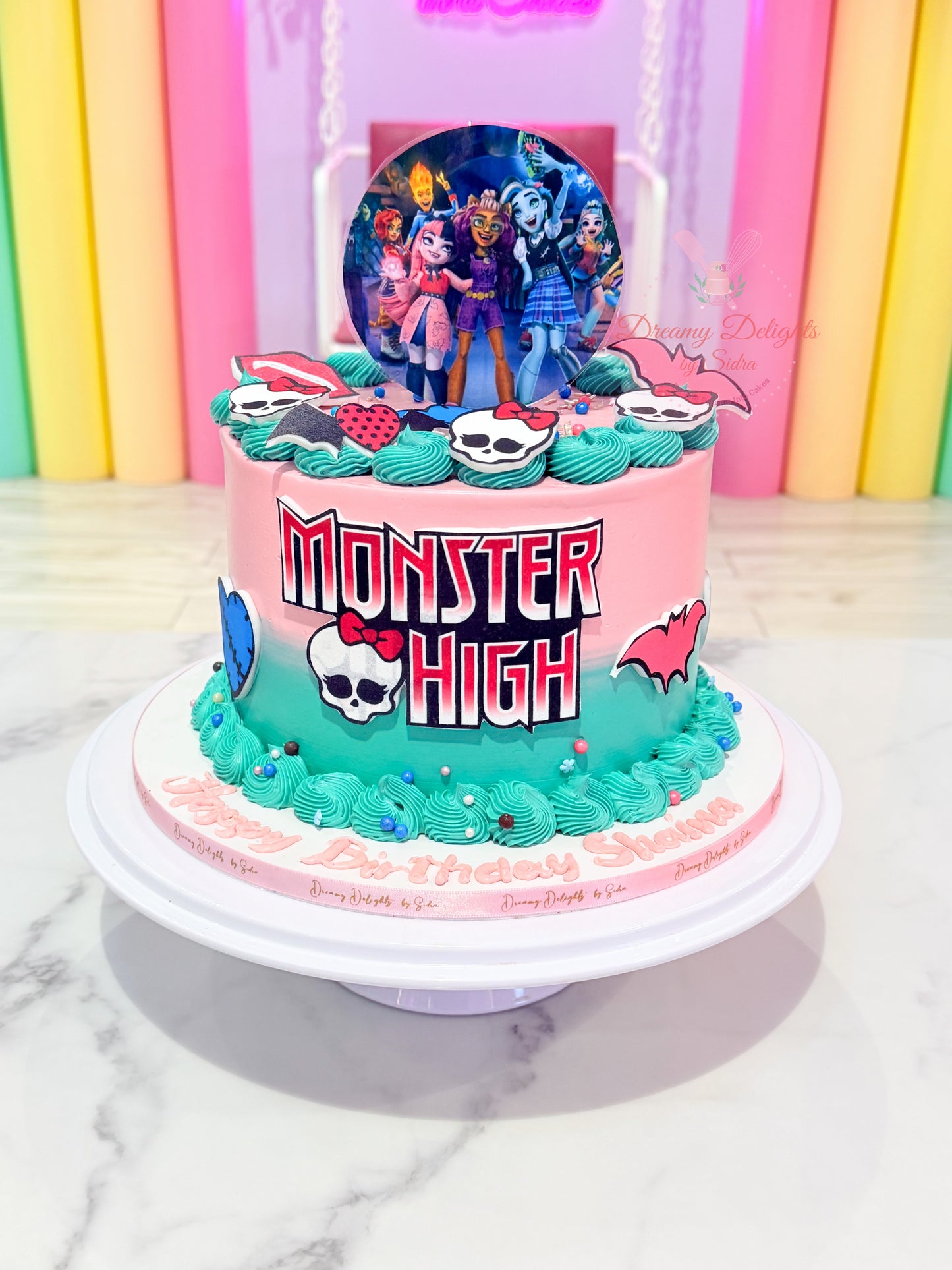 Monster High birthday cake for girls with colorful fondant design and character toppers