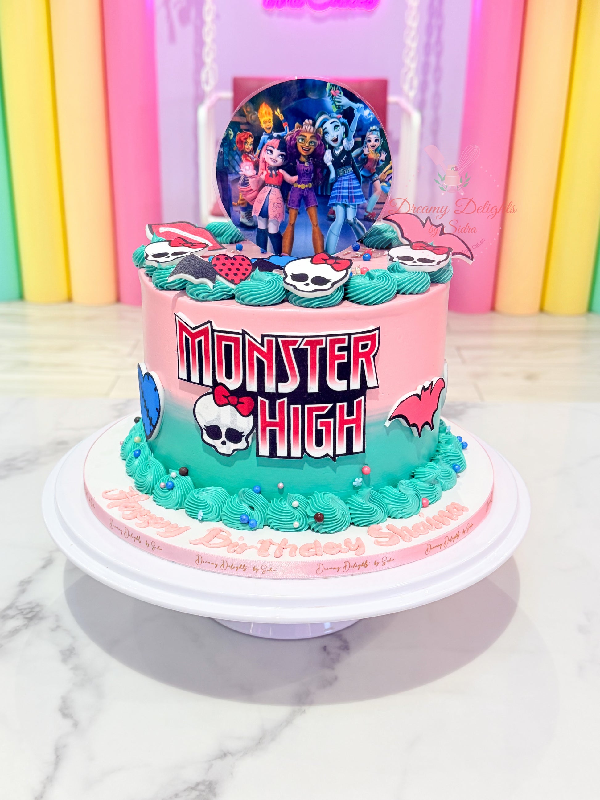 Monster High birthday cake for girls with colorful fondant design and character toppers